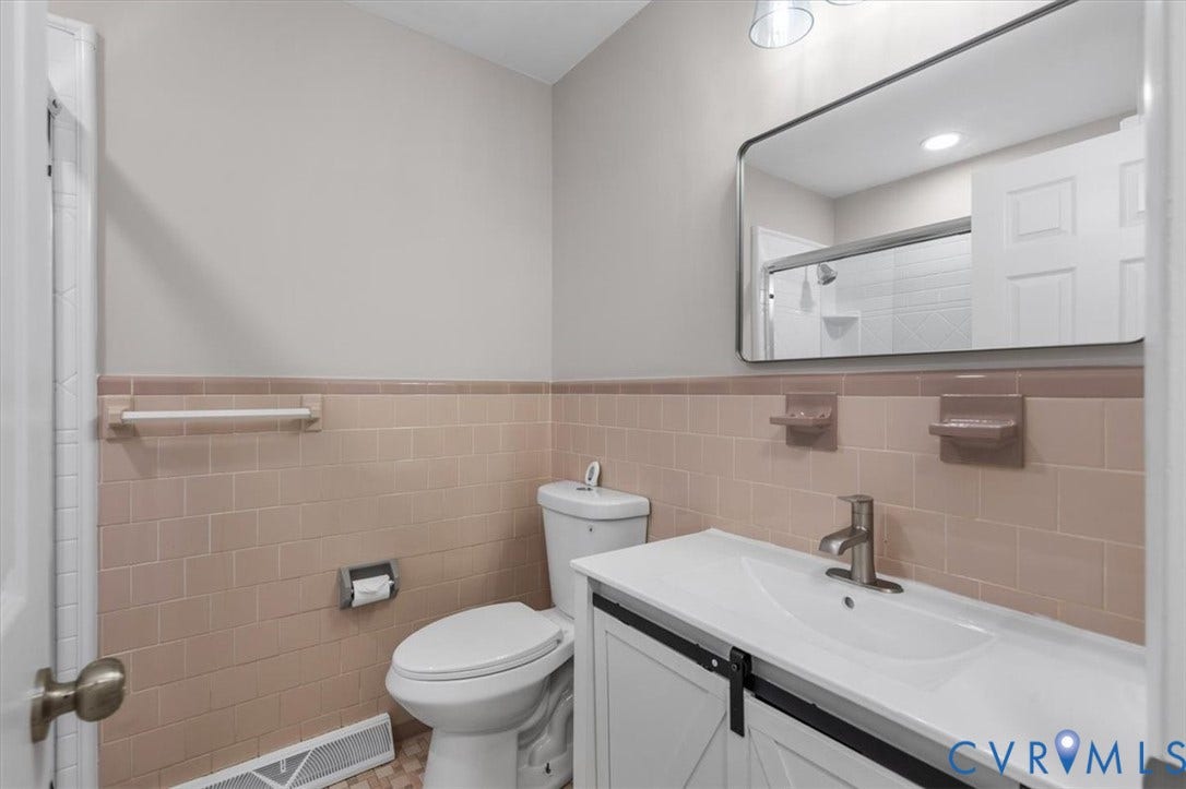 3308 Sylvania Road, Chesterfield, VA 23831 Bathroom featuring a vanity with a barn door style front, integrated sink, and brushed nickel faucet
