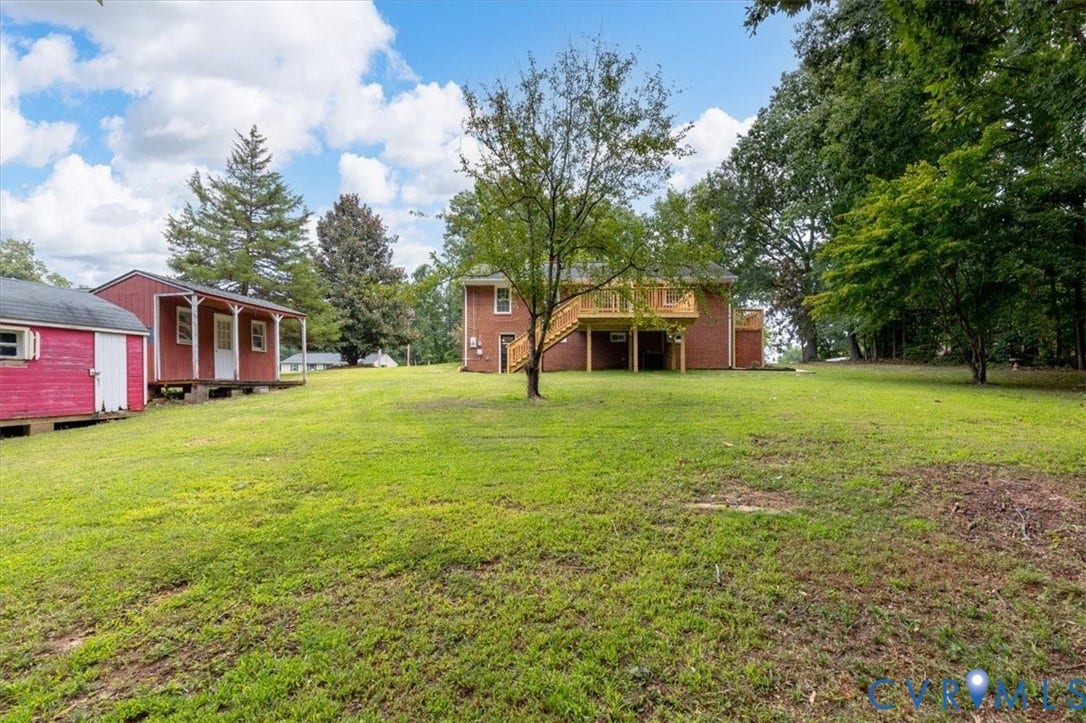 3308 Sylvania Road, Chesterfield, VA 23831 Expansive green space featuring a brick exterior residence with an elevated wood deck and mature trees