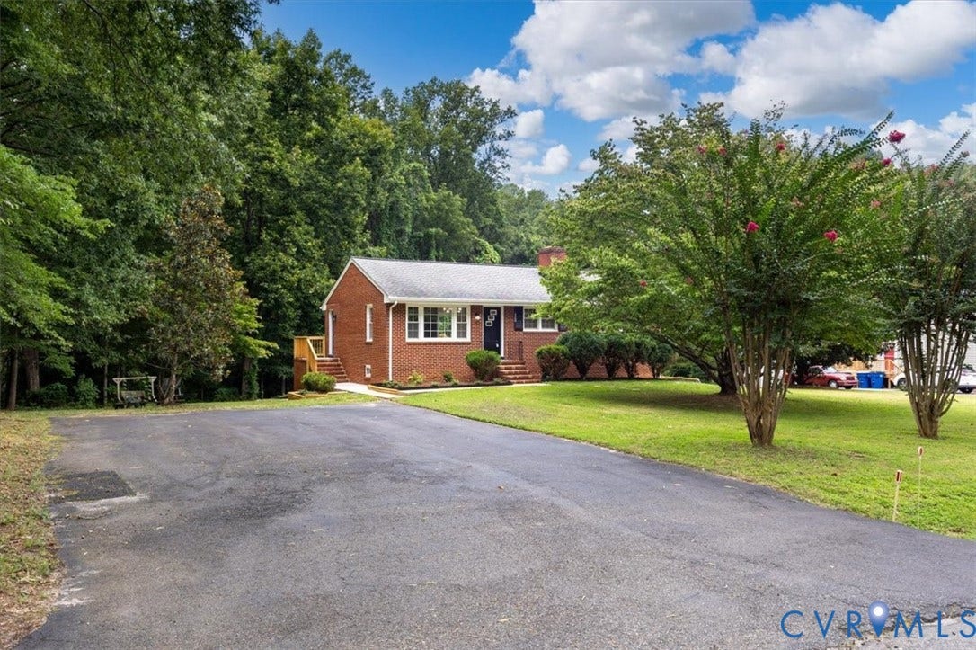 3308 Sylvania Road, Chesterfield, VA 23831 Brick exterior home featuring a paved driveway, front lawn, and mature trees
