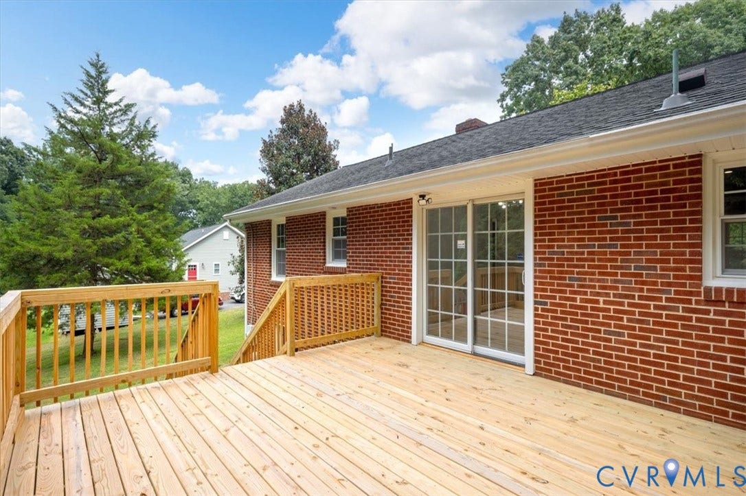 3308 Sylvania Road, Chesterfield, VA 23831 Expansive wood deck with railing, brick exterior, and sliding glass door access