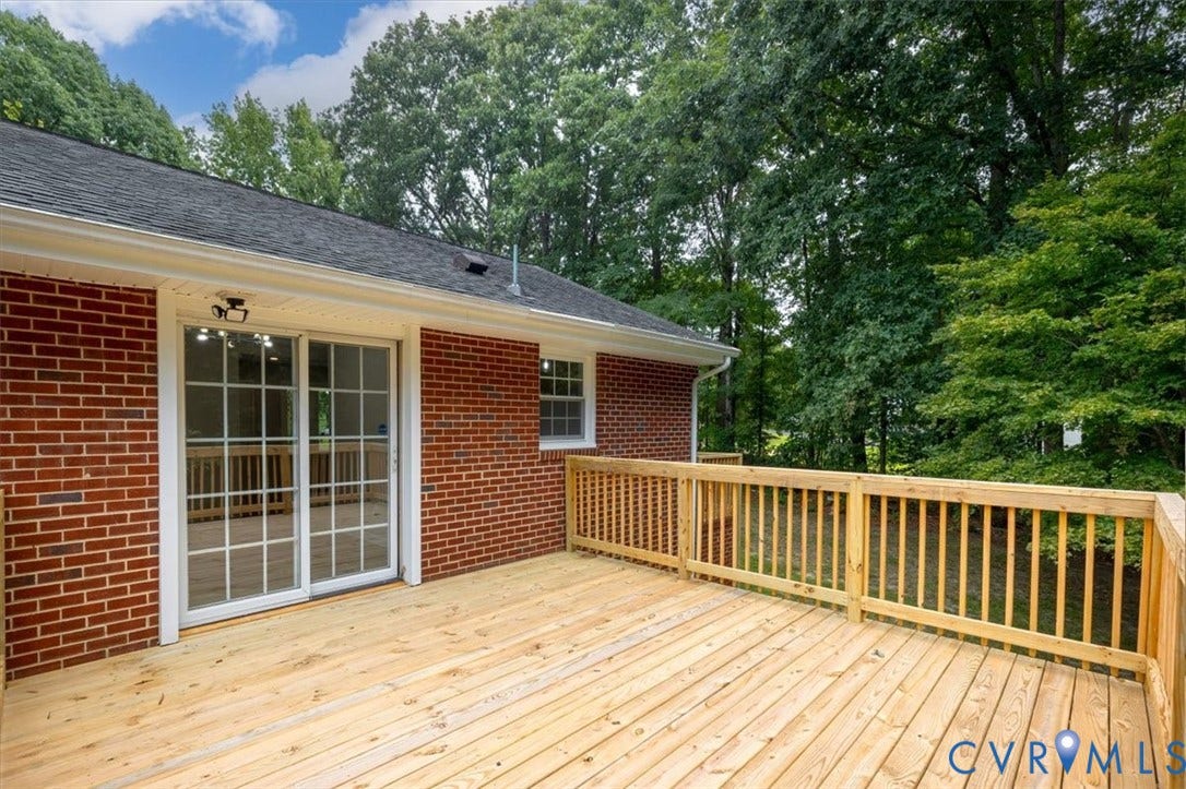 3308 Sylvania Road, Chesterfield, VA 23831 Expansive wood deck with a natural finish, wood railing, and brick exterior