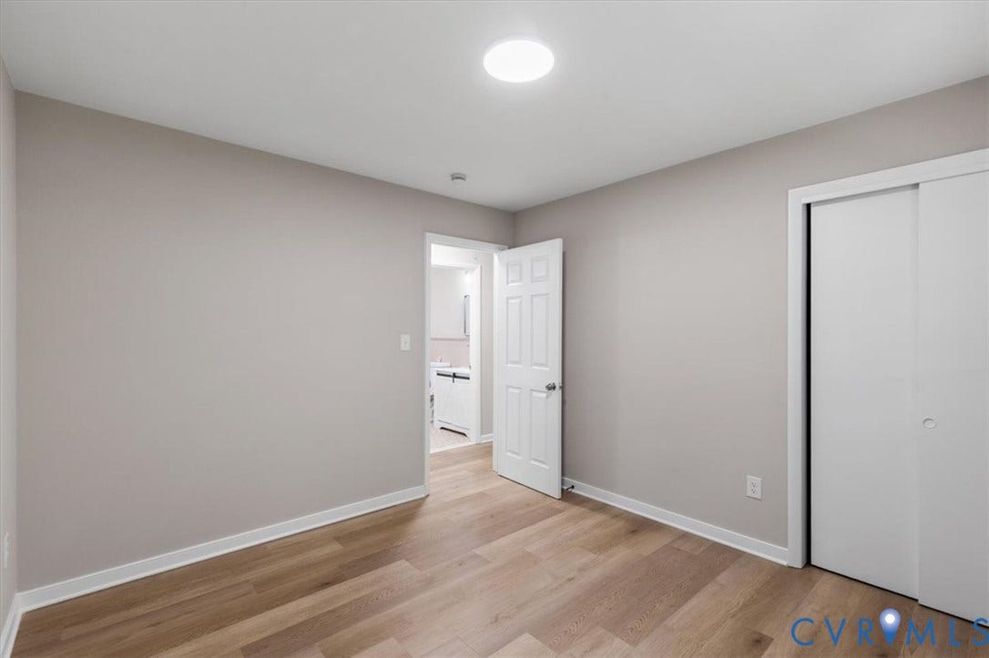 3308 Sylvania Road, Chesterfield, VA 23831 Wood-finish flooring, neutral wall tones, interior door, sliding closet doors, and a ceiling-mounted light fixture