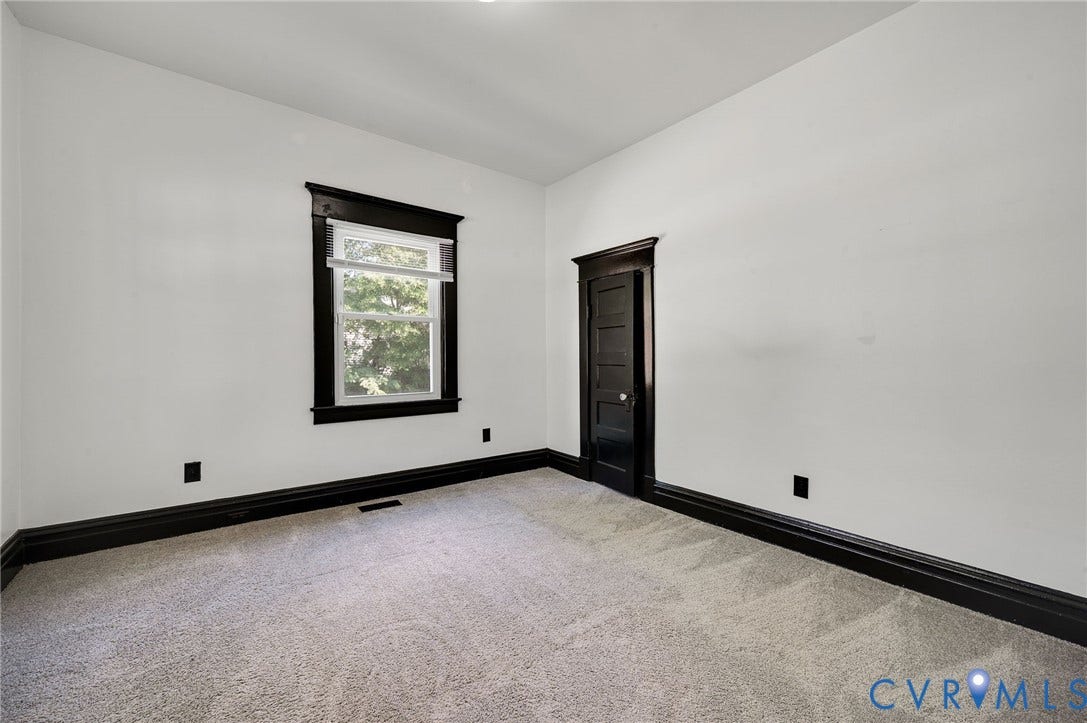 Crisp white walls with contrasting dark trim and doors