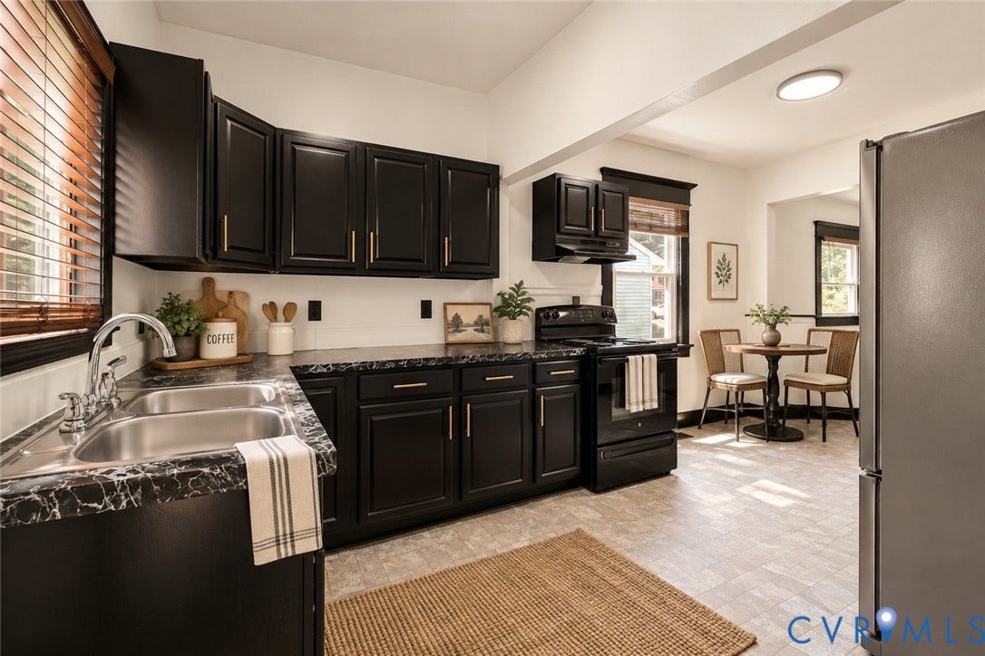 Kitchen featuring dark cabinetry, dark patterned countertops, a stainless steel double basin sink, and a black range with an overhead microwave