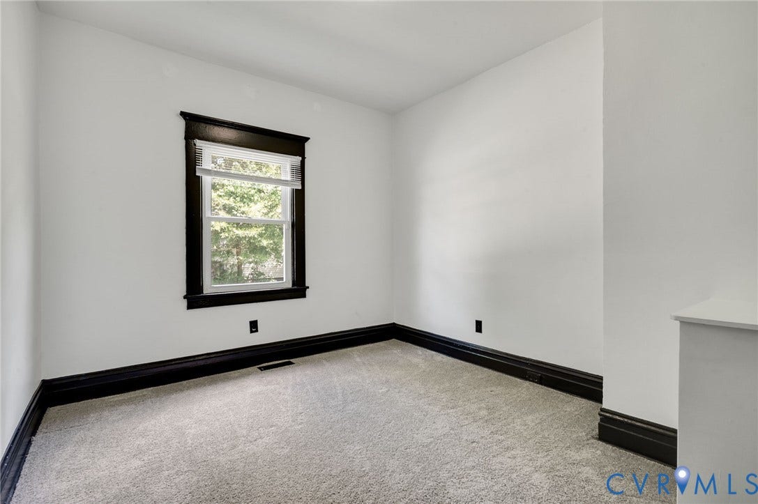 Light-colored wall-to-wall carpeting with dark trim detailing