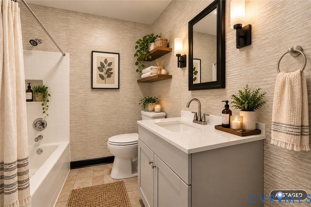 Bathroom featuring a single vanity with a white countertop and undermount sink, brushed nickel faucet, and gray cabinetry