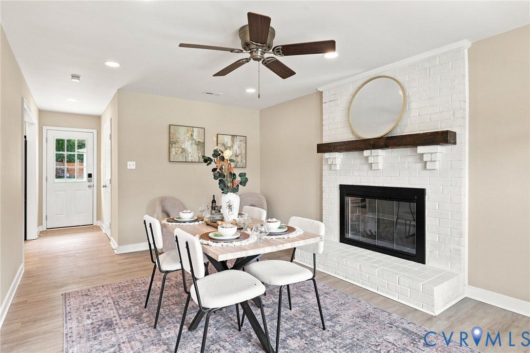 3221 Clintwood Road, Midlothian, VA 23112 White-painted brick fireplace with a dark wood mantel and hearth