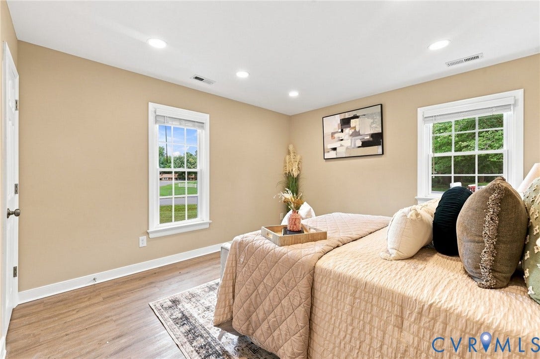 3221 Clintwood Road, Midlothian, VA 23112 Recessed ceiling lighting, two windows with white trim, wood-finish flooring, and light-toned wall paint