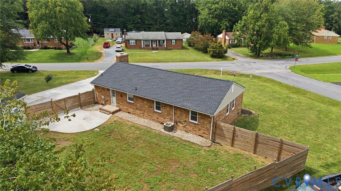 3221 Clintwood Road, Midlothian, VA 23112 Brick exterior with a dark shingle roof, featuring a private fenced yard and a curved concrete patio