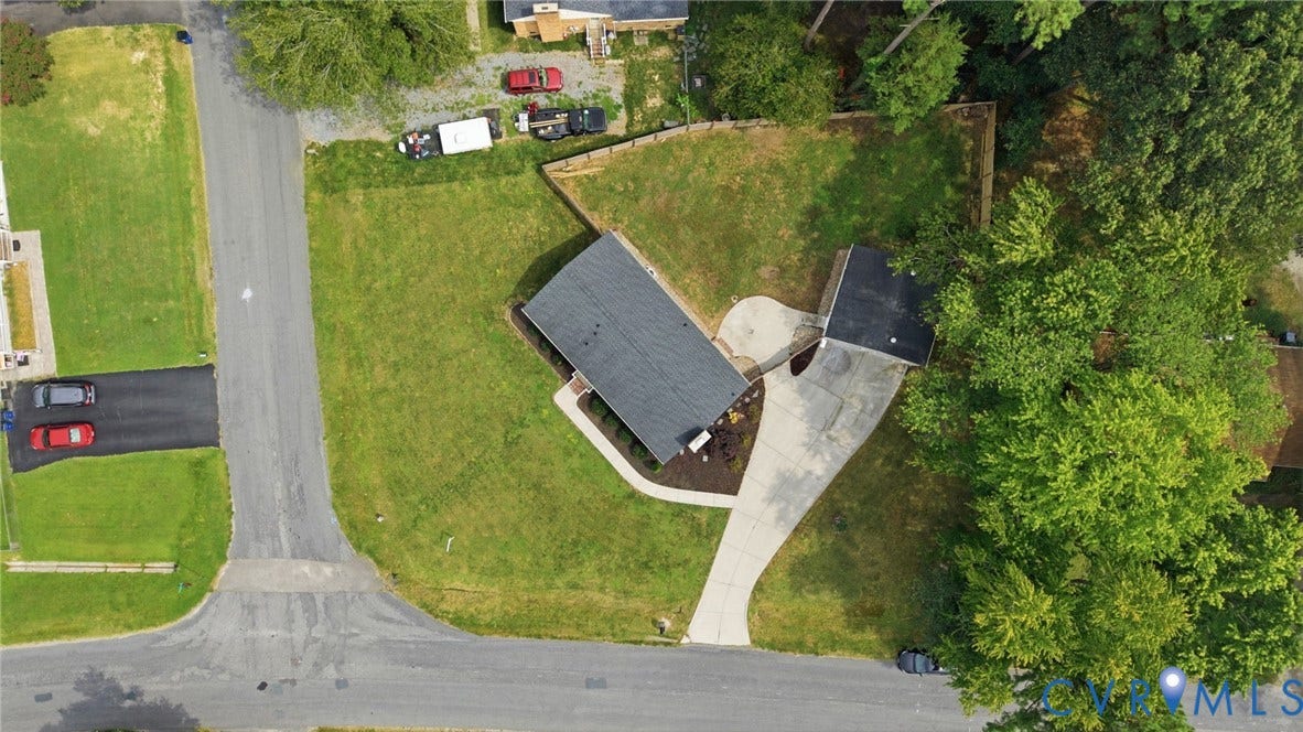 3221 Clintwood Road, Midlothian, VA 23112 Property featuring a dark shingle roof, expansive green lawn, mature trees, and a concrete driveway