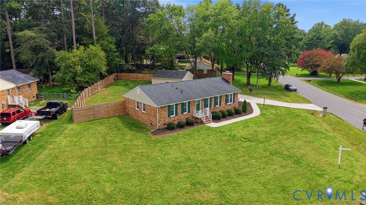 3221 Clintwood Road, Midlothian, VA 23112 Brick facade with green shutters, a dark shingle roof, and a front entry with white railings