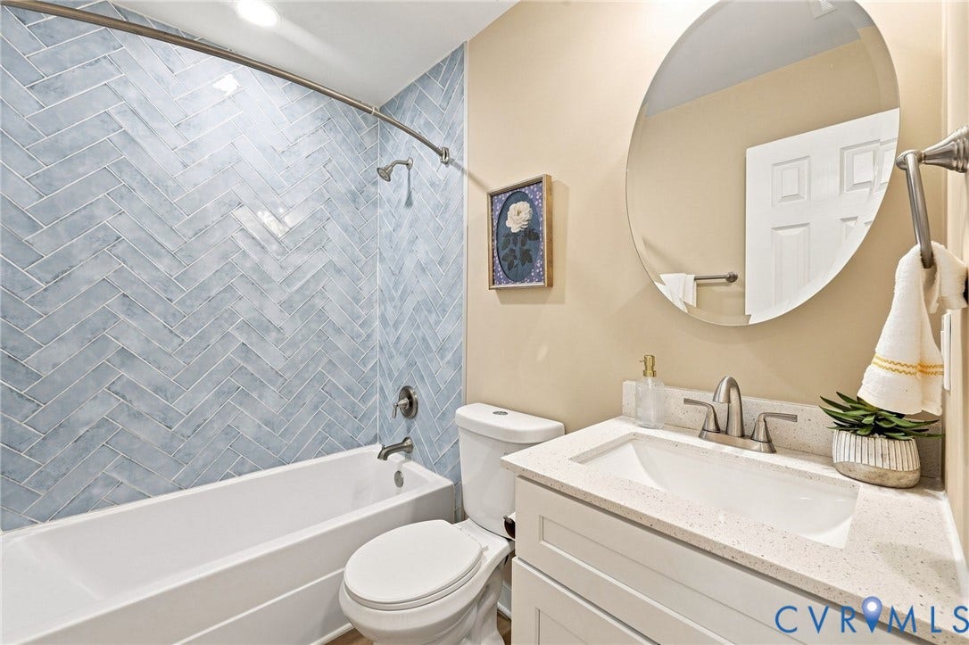 3221 Clintwood Road, Midlothian, VA 23112 Bathroom featuring a vanity with an integrated sink, a rounded mirror, and a white toilet