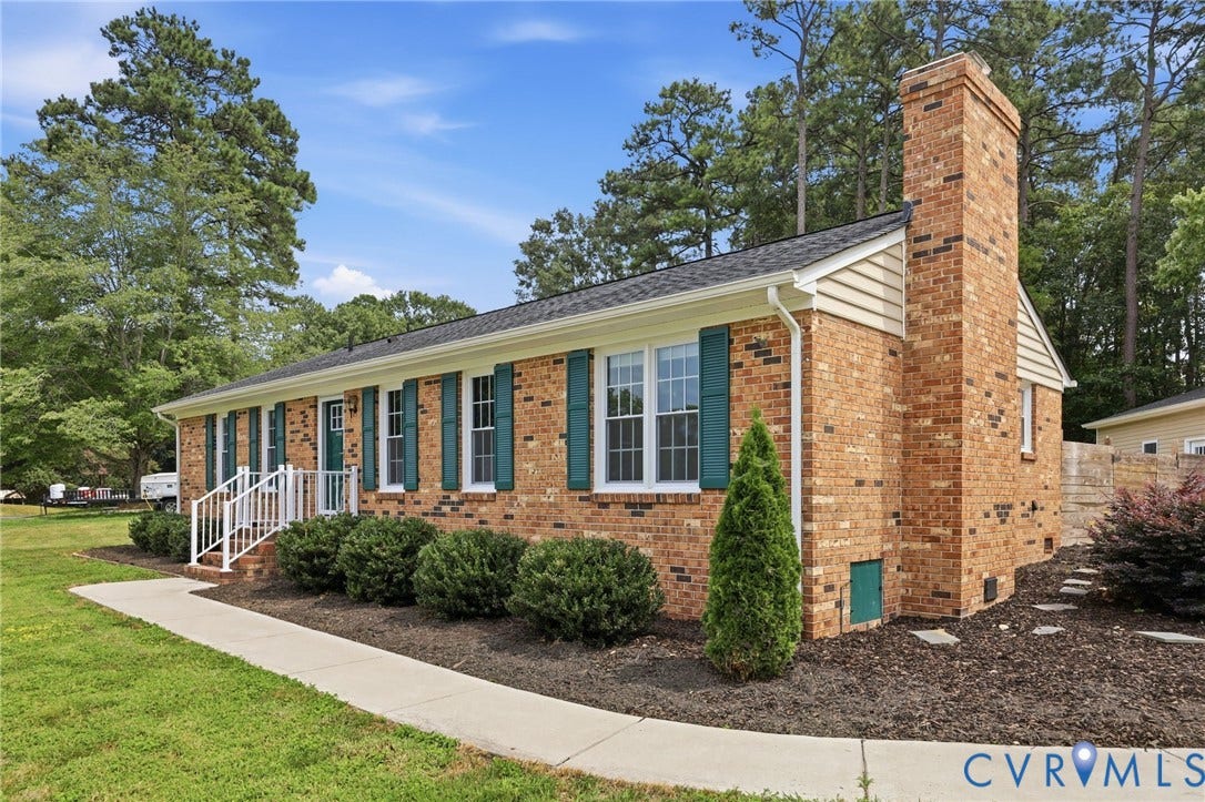 3221 Clintwood Road, Midlothian, VA 23112 Brick exterior with a prominent chimney, white window frames, and green shutters