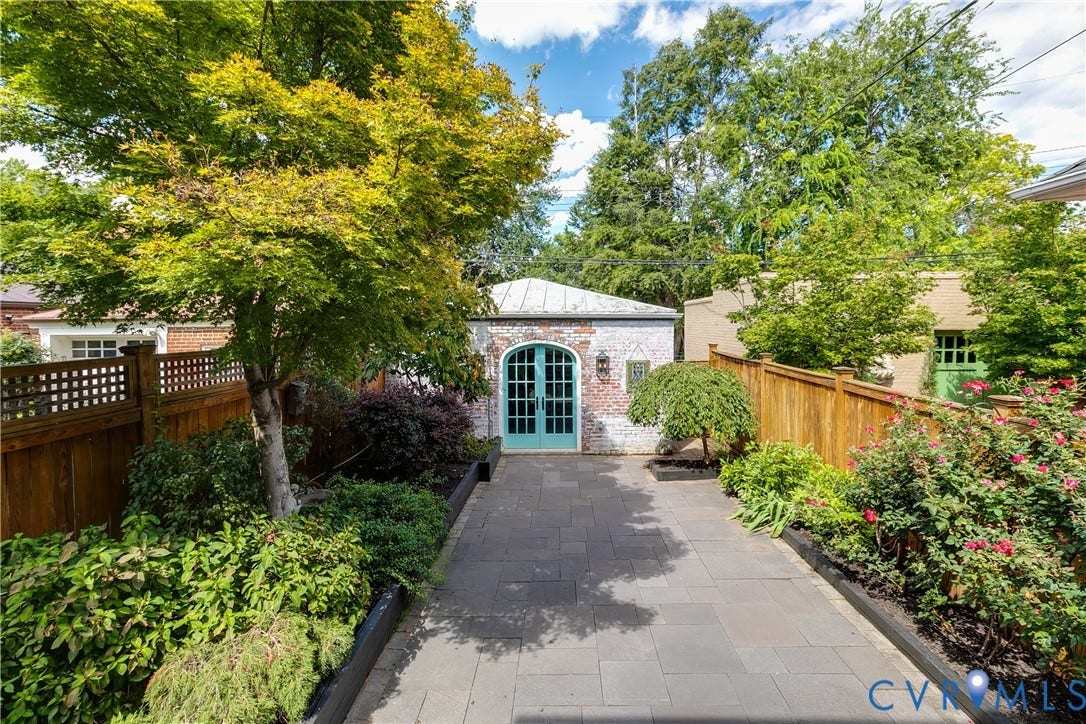 The home has a lovely rear deck, a hardscaped patio and a TWO CAR GARAGE!