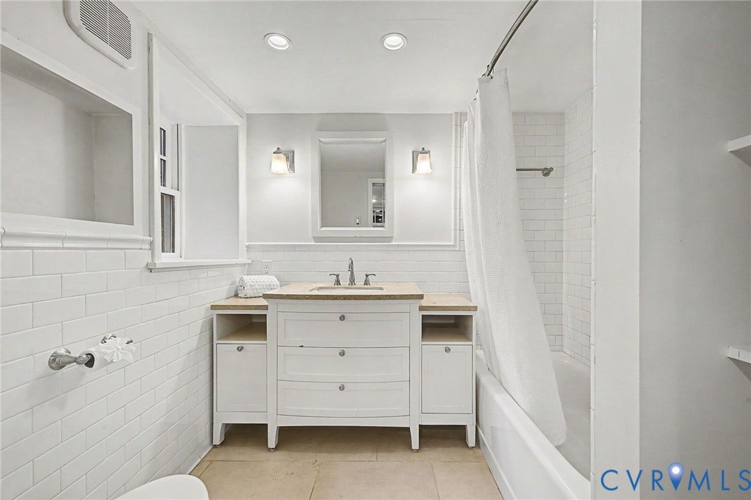 White subway tile wainscoting and shower surround