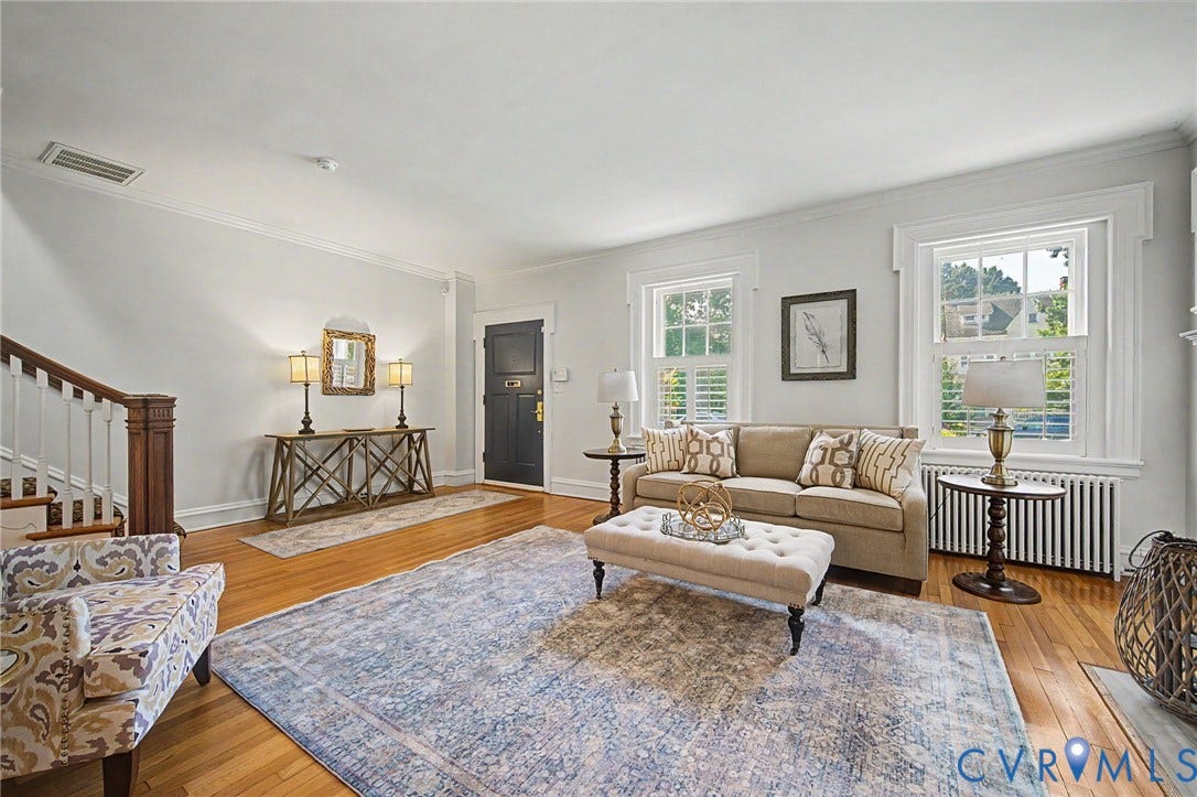 Hardwood flooring, white crown molding, white window trim, and a built-in staircase
