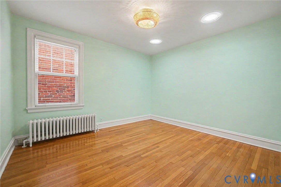 Hardwood flooring, recessed lighting, and a prominent window