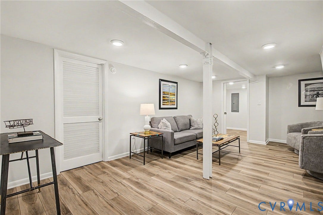 Recessed lighting illuminating the space, with wood-finish flooring and white walls