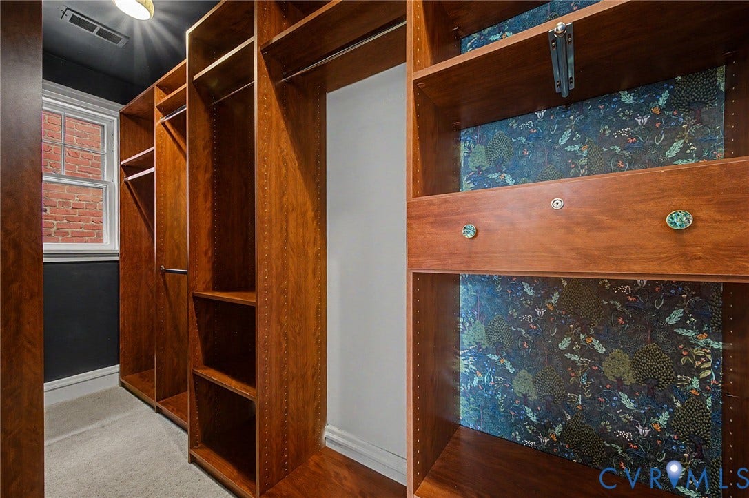 Custom built-in closet system with multiple shelving units and integrated hanging rods