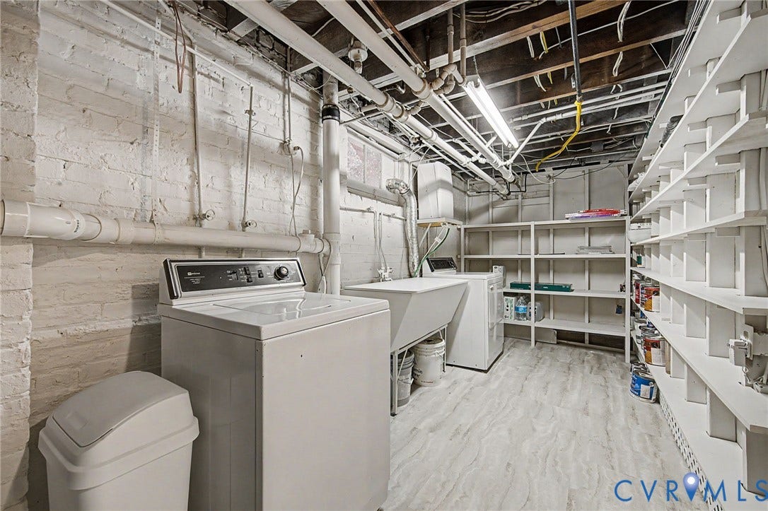 Painted brick walls with exposed overhead utilities