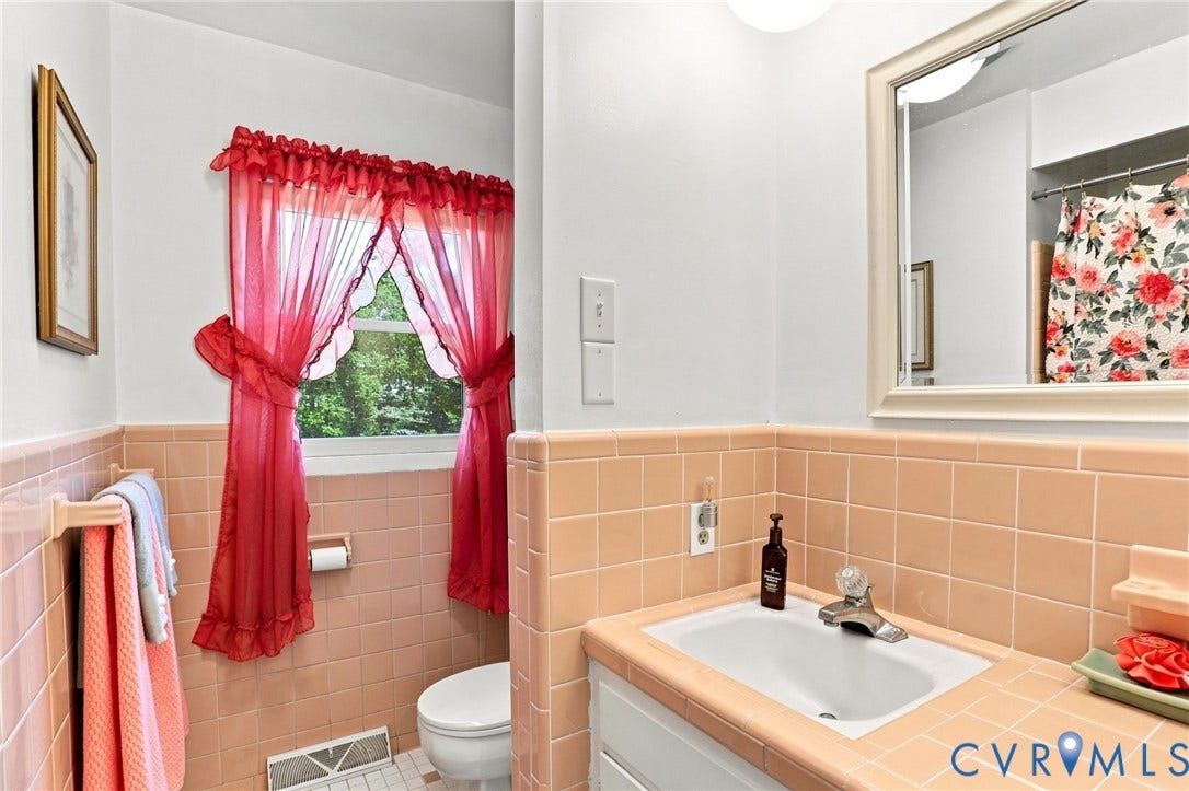 4512 Forrestal Road, Chester, VA 23831 Bathroom featuring a vanity with an integrated sink, a wall-mounted mirror, and tiled walls