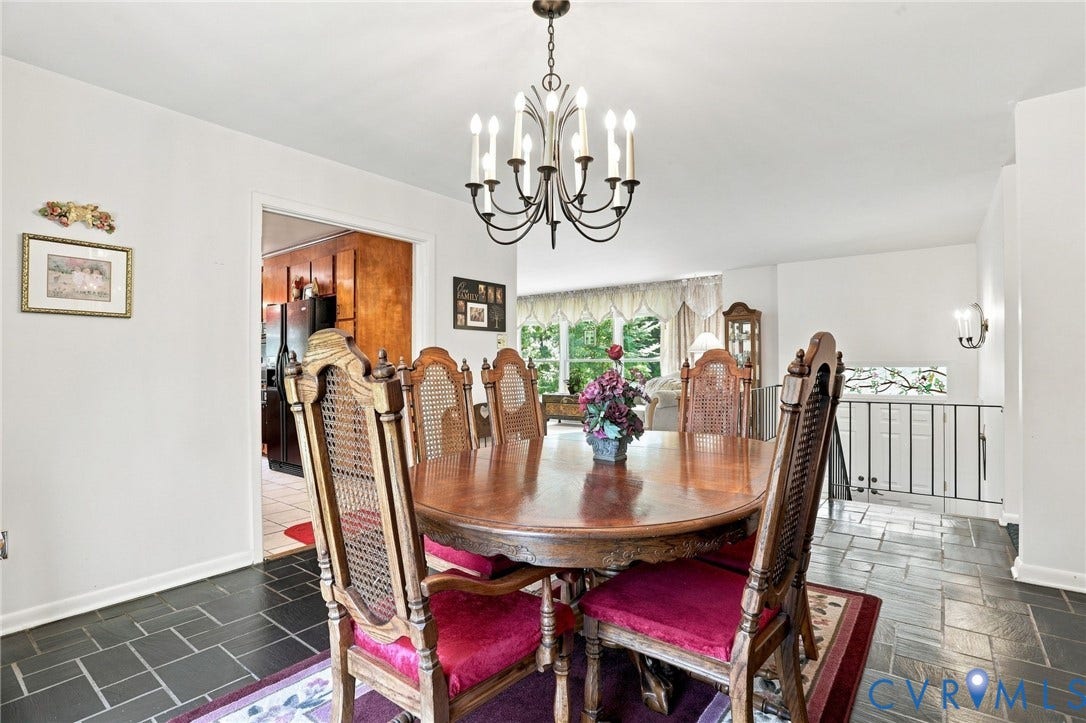 4512 Forrestal Road, Chester, VA 23831 Dining area featuring a dark-toned tile floor, a classic chandelier, and an open doorway to another room