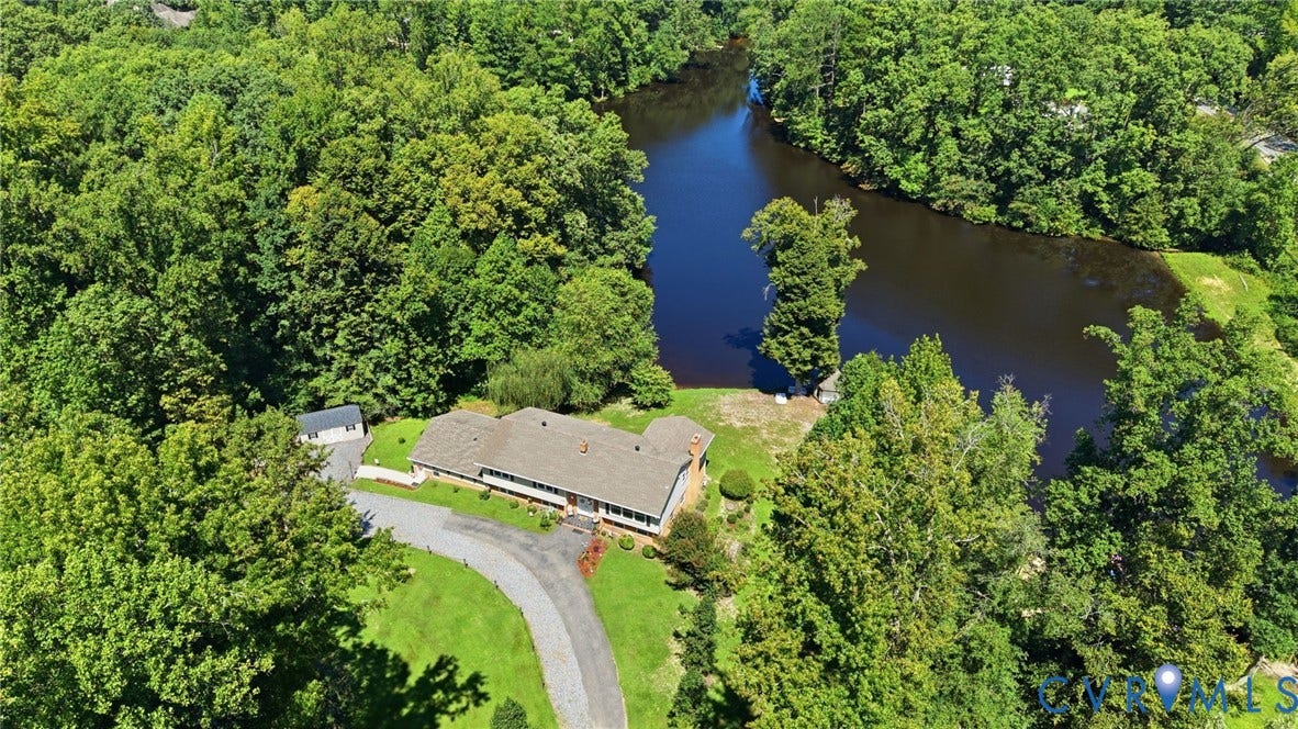 4512 Forrestal Road, Chester, VA 23831 Secluded riverside property nestled within mature woodland, featuring a single-story structure with direct waterfront access