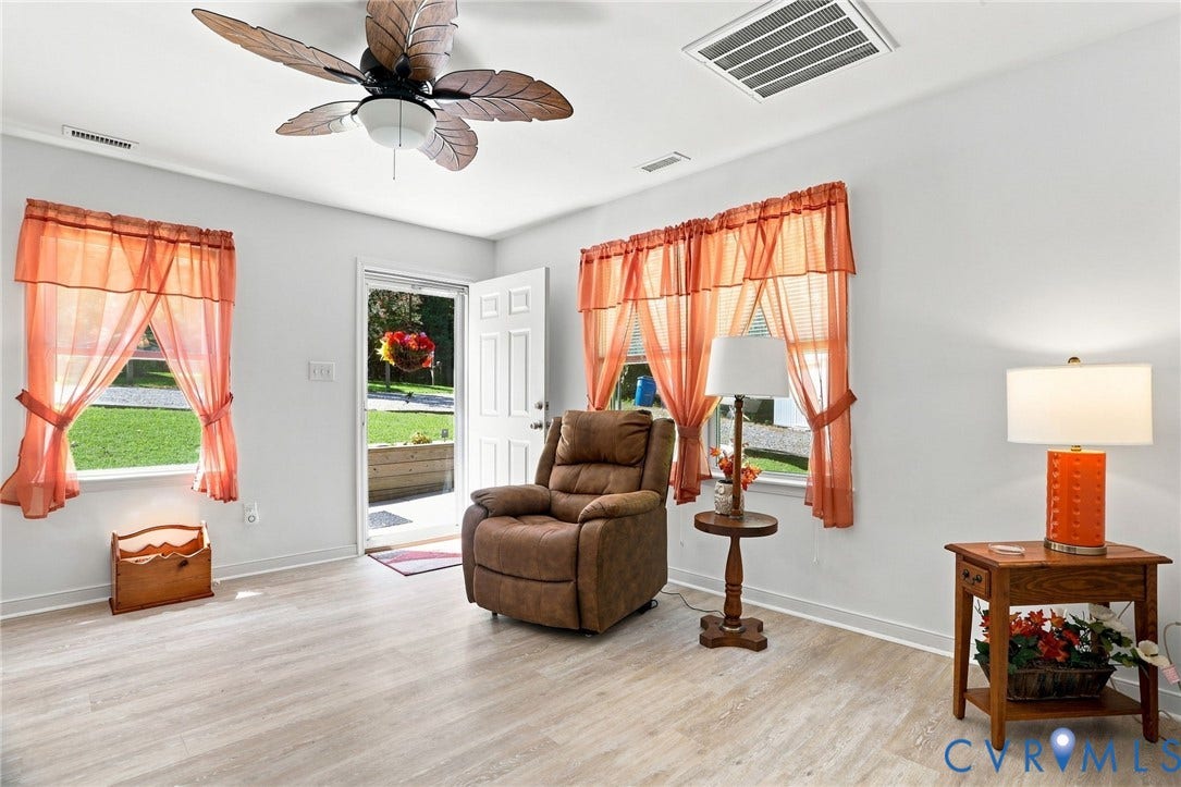 4512 Forrestal Road, Chester, VA 23831 Wood-finish flooring, white walls, and a ceiling fan with decorative blades