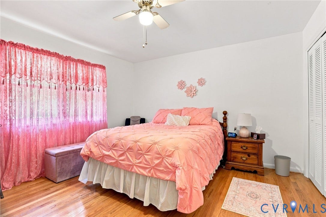 4512 Forrestal Road, Chester, VA 23831 Hardwood flooring, ceiling fan with light fixture, window with natural light, and louvered bi-fold closet doors