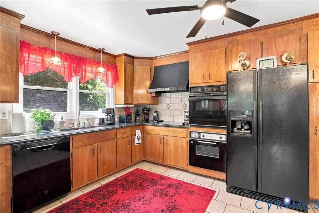 4512 Forrestal Road, Chester, VA 23831 Warm wood cabinetry and stainless steel appliances define this kitchen, featuring a black cooktop and double wall ovens for convenient meal preparation