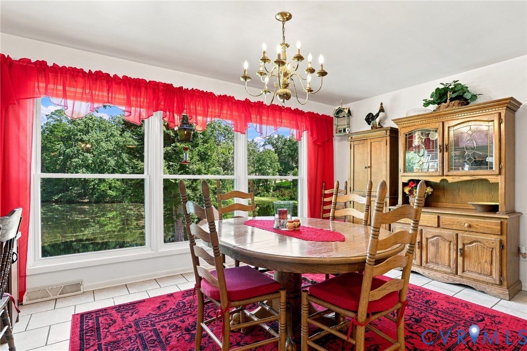 4512 Forrestal Road, Chester, VA 23831 Elegant dining room showcasing a wood-finish table, coordinating ladder-back chairs, and ceramic tile flooring