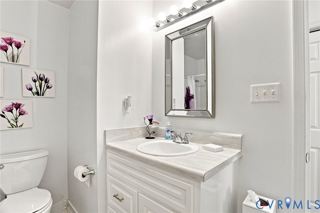4512 Forrestal Road, Chester, VA 23831 White vanity with paneled doors, an integrated sink, and a countertop