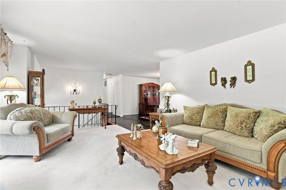 4512 Forrestal Road, Chester, VA 23831 Sophisticated living room featuring soaring ceilings, abundant natural light from multiple windows, and refined wood-finish flooring throughout