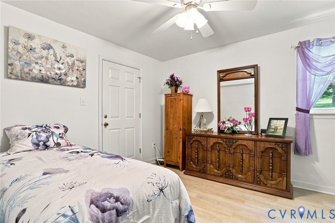 4512 Forrestal Road, Chester, VA 23831 Wood-finish flooring with white walls and a white ceiling fan