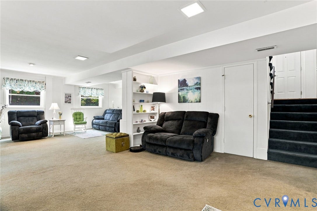 4512 Forrestal Road, Chester, VA 23831 Spacious basement recreation room featuring neutral carpeting, recessed ceiling lighting, and built-in shelving with display space