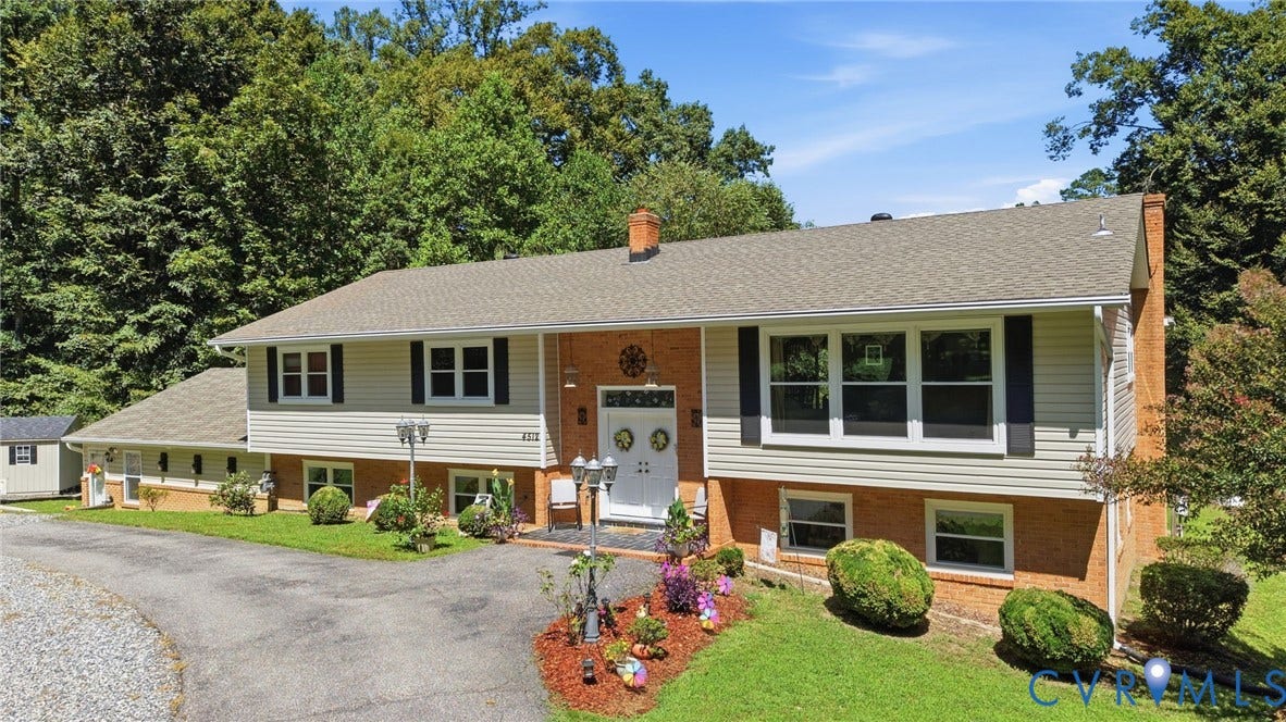 4512 Forrestal Road, Chester, VA 23831 Split-level residence featuring brick and siding exterior, a light gray shingle roof, and a gravel driveway