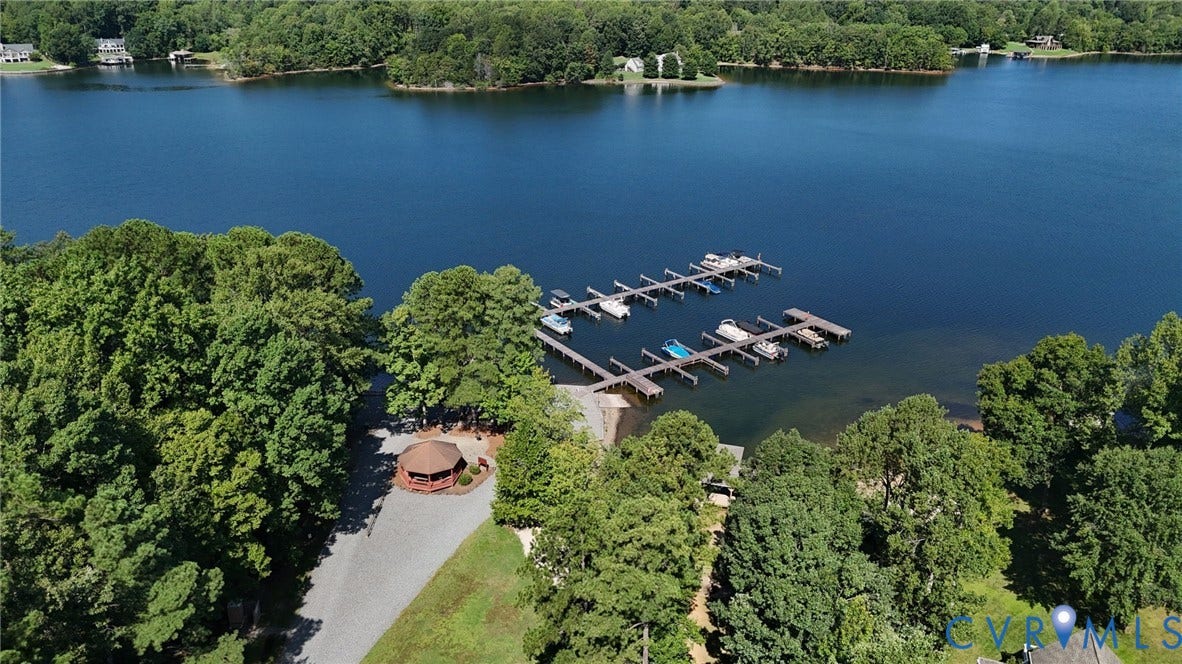 1577 Moody Town Road, Bumpass, VA 23024 Waterfront property with extensive boat docks, gravel parking area, and a large gazebo