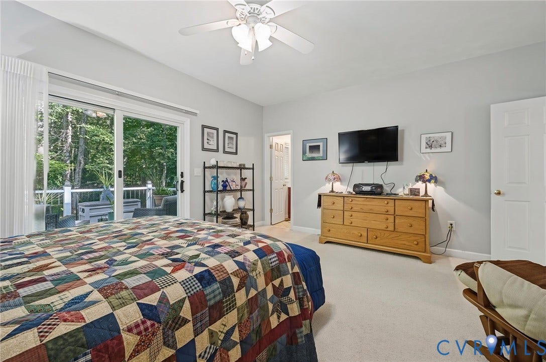 1577 Moody Town Road, Bumpass, VA 23024 Sliding glass doors leading to an exterior deck, vaulted ceiling, and ceiling fan