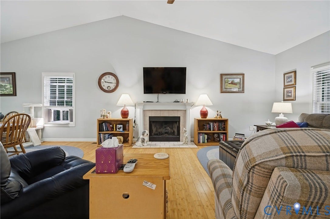 1577 Moody Town Road, Bumpass, VA 23024 Vaulted ceiling, fireplace with mantel, wood-finish flooring, multiple windows, recessed lighting