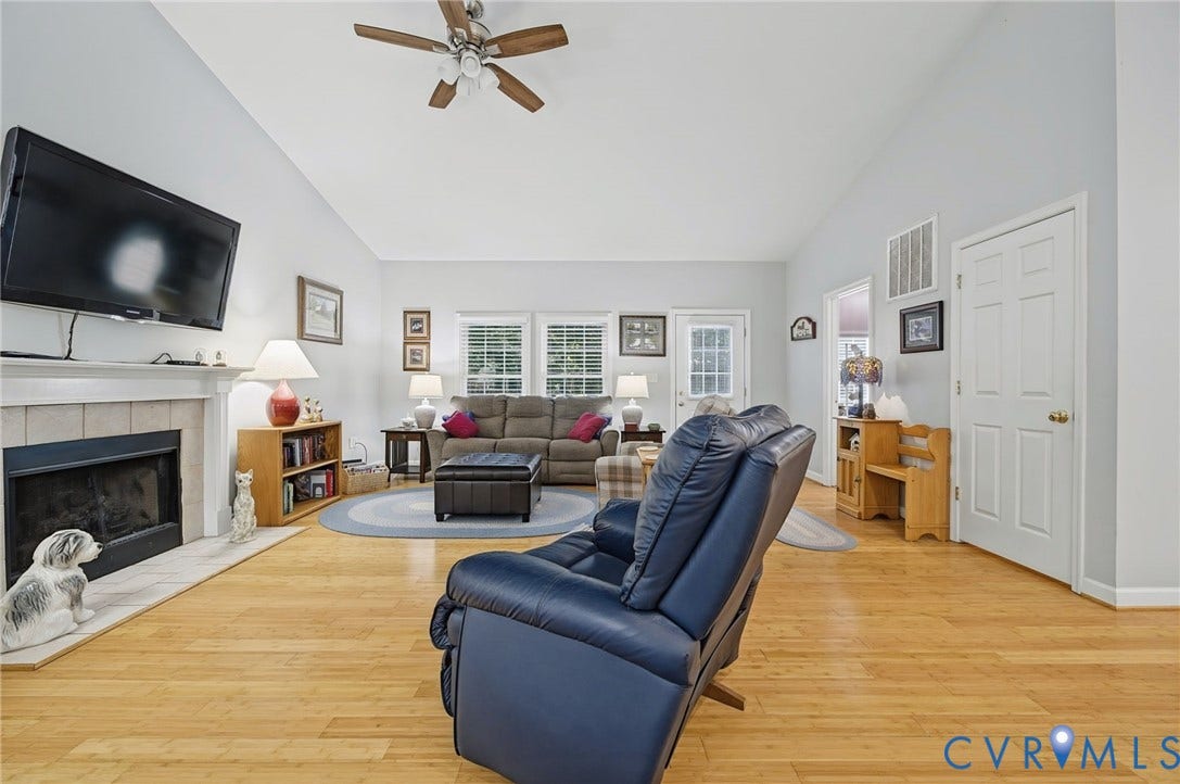 1577 Moody Town Road, Bumpass, VA 23024 Living area featuring a fireplace with a mantel, light wood-finish flooring, and a ceiling fan