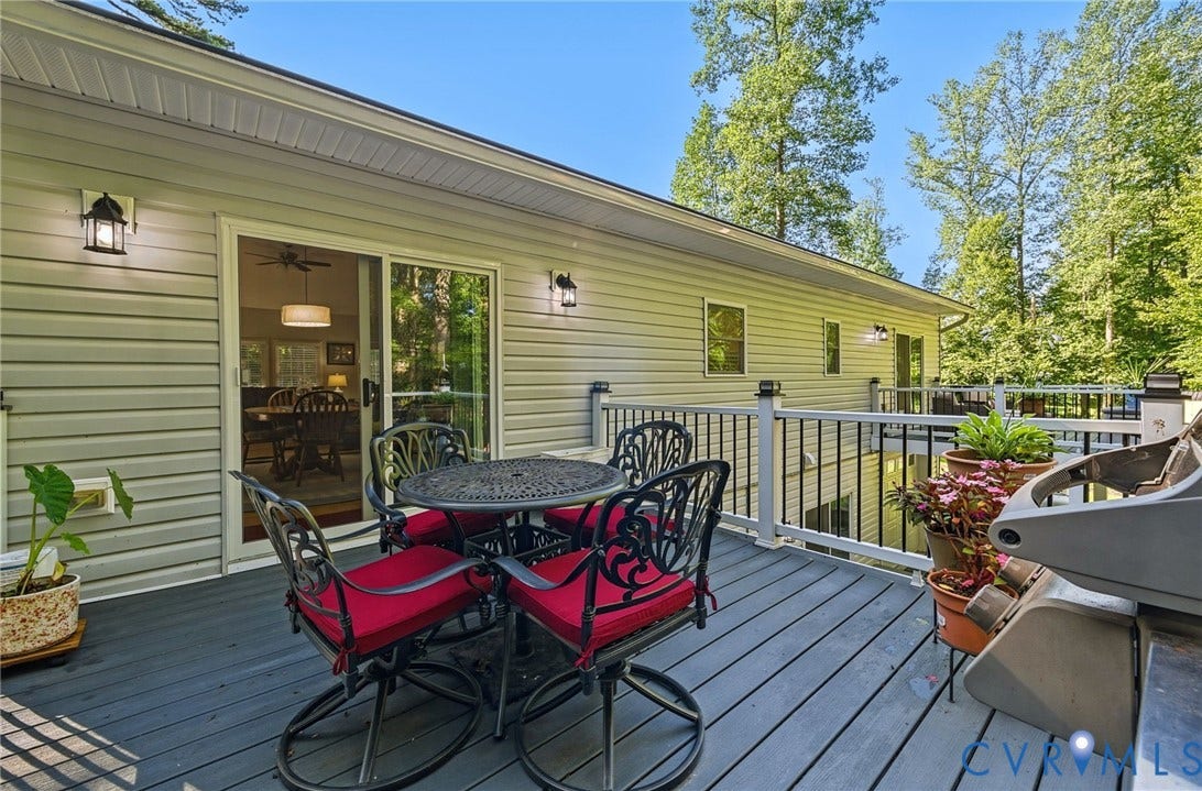 1577 Moody Town Road, Bumpass, VA 23024 Expansive outdoor deck with gray composite flooring, white railings, and black balusters