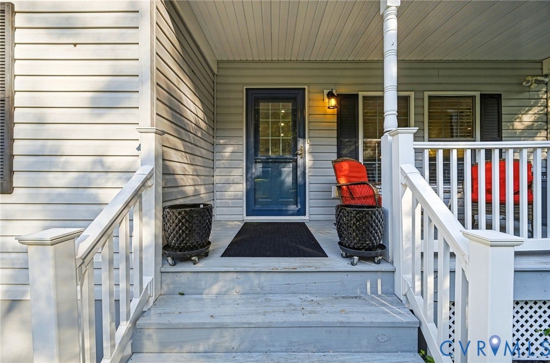 1577 Moody Town Road, Bumpass, VA 23024 Front entry featuring a blue door with glass inserts, white siding, and a covered porch with white railings