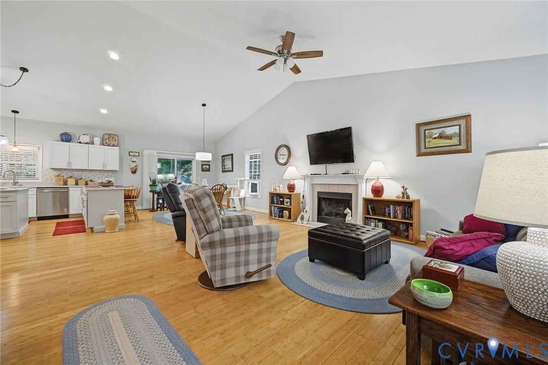 1577 Moody Town Road, Bumpass, VA 23024 Cathedral ceiling with wood-finish flooring, featuring a fireplace with a mantel, recessed lighting, and a ceiling fan