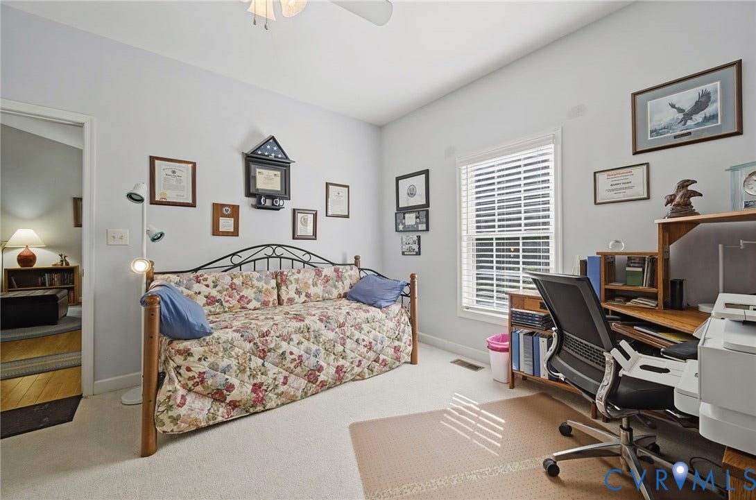 1577 Moody Town Road, Bumpass, VA 23024 Recessed window with white blinds, neutral carpeting, and a ceiling fan with light fixture