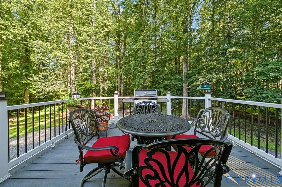 1577 Moody Town Road, Bumpass, VA 23024 Expansive outdoor deck featuring composite decking, white railing with black balusters, and integrated post cap lighting