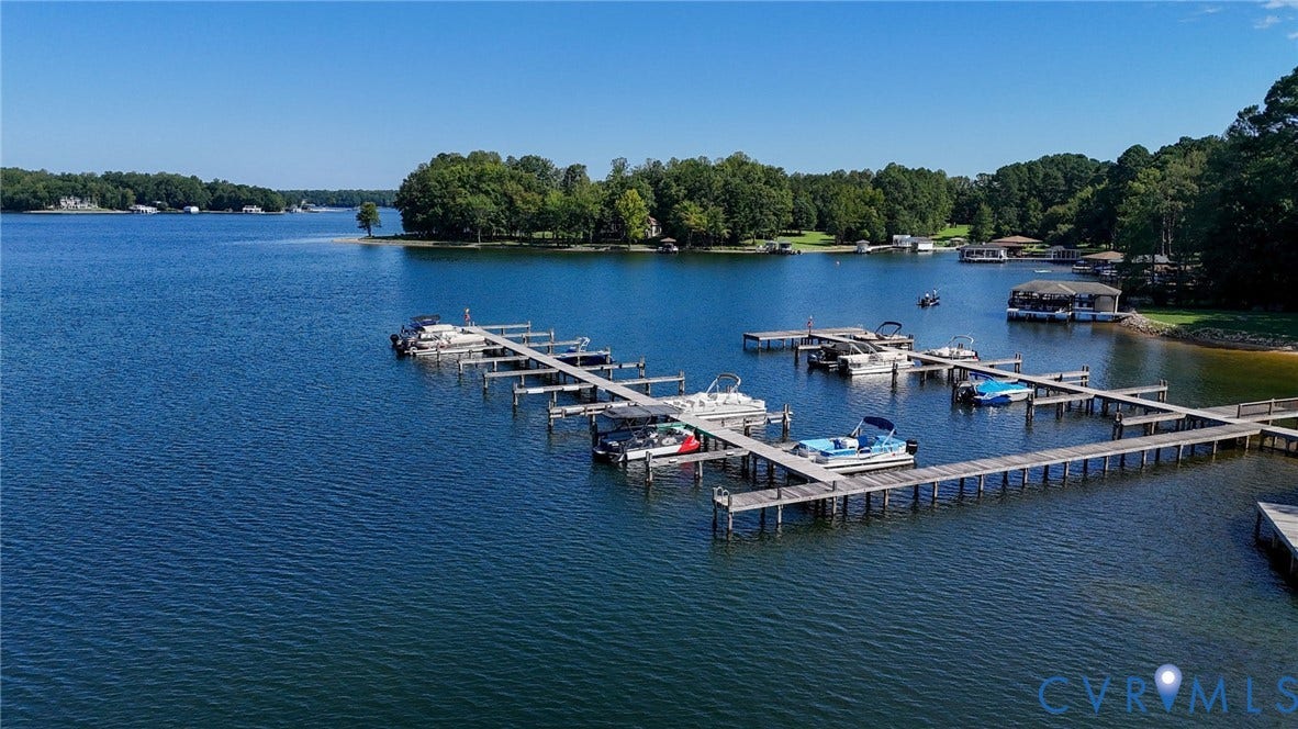 1577 Moody Town Road, Bumpass, VA 23024 Expansive waterfront with multiple boat slips, extensive wooden dockage, and direct water access