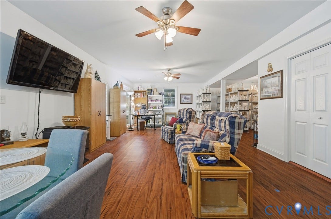 1577 Moody Town Road, Bumpass, VA 23024 Wood-finish flooring throughout, bright white walls, and multiple ceiling fans with integrated lighting