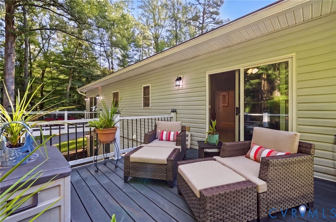1577 Moody Town Road, Bumpass, VA 23024 Spacious outdoor deck featuring composite decking, white railings with black balusters, and a sliding glass door