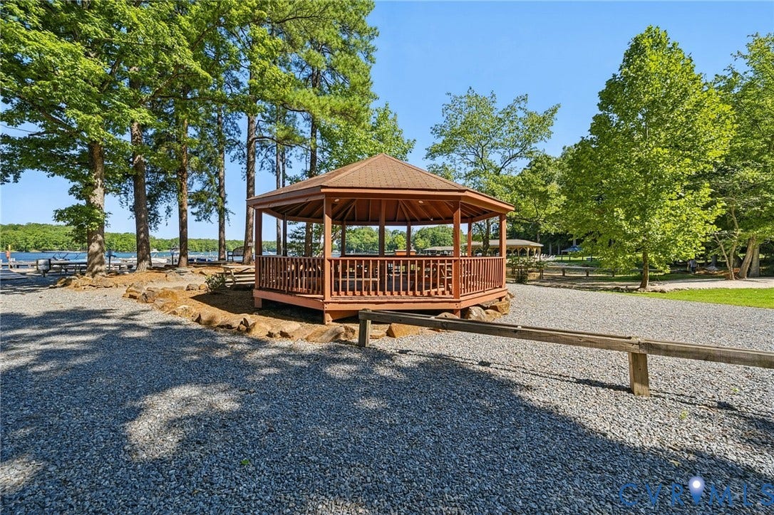 1577 Moody Town Road, Bumpass, VA 23024 Octagonal gazebo with a brown shingle roof, surrounded by mature trees and a gravel surface