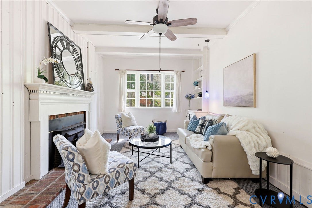 3400 Warner Road, Grandview, Richmond, VA 23225 White plank wall paneling, painted wood ceiling beams, white fireplace with brick hearth, multi-pane window, built-in bookcase and ceiling fan w/light